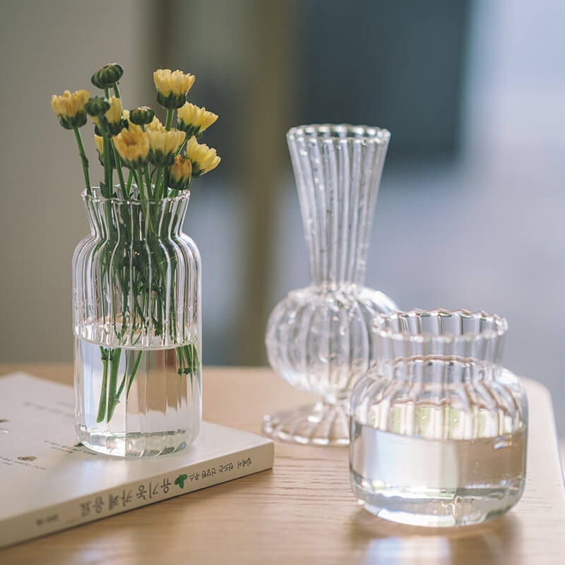 Glass vases with yellow flowers.