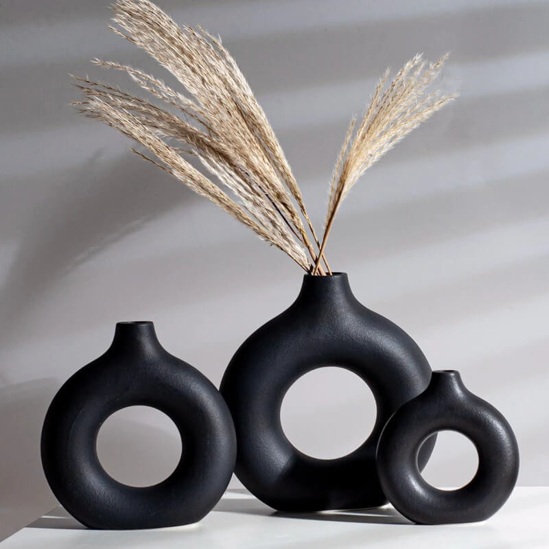 Black ceramic vases with decorative dried grass
