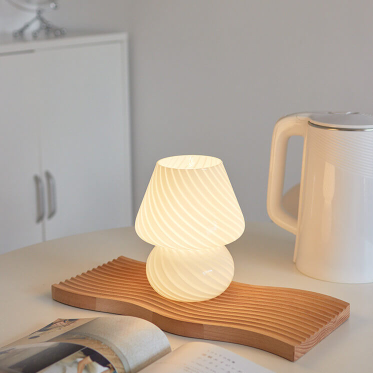 Mushroom-shaped lamp on wooden tray.