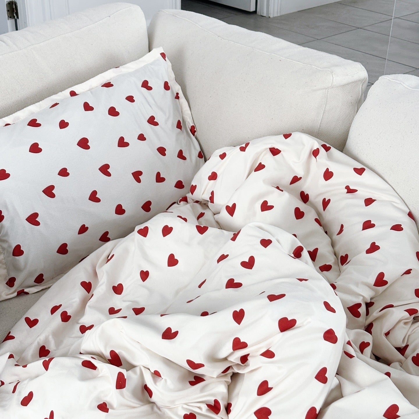 Heart-patterned bedding on a white couch