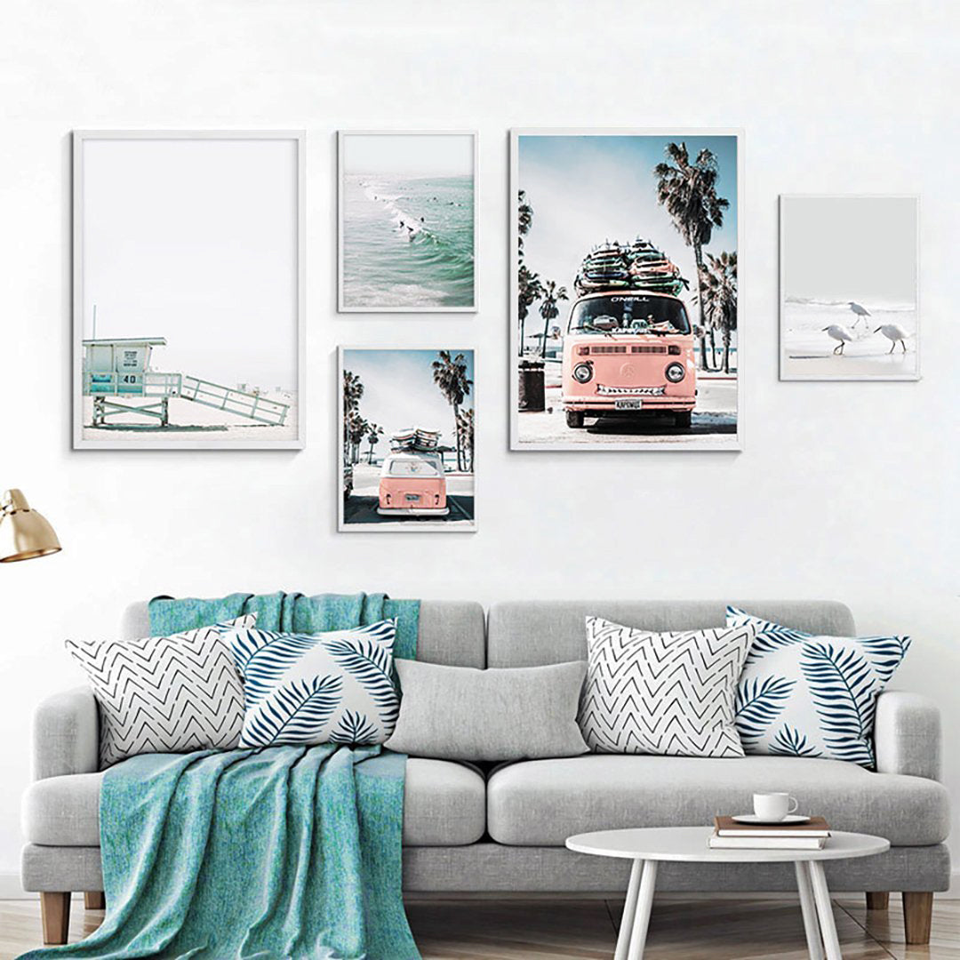 Coastal wall art featuring pink van and beach scenes.
