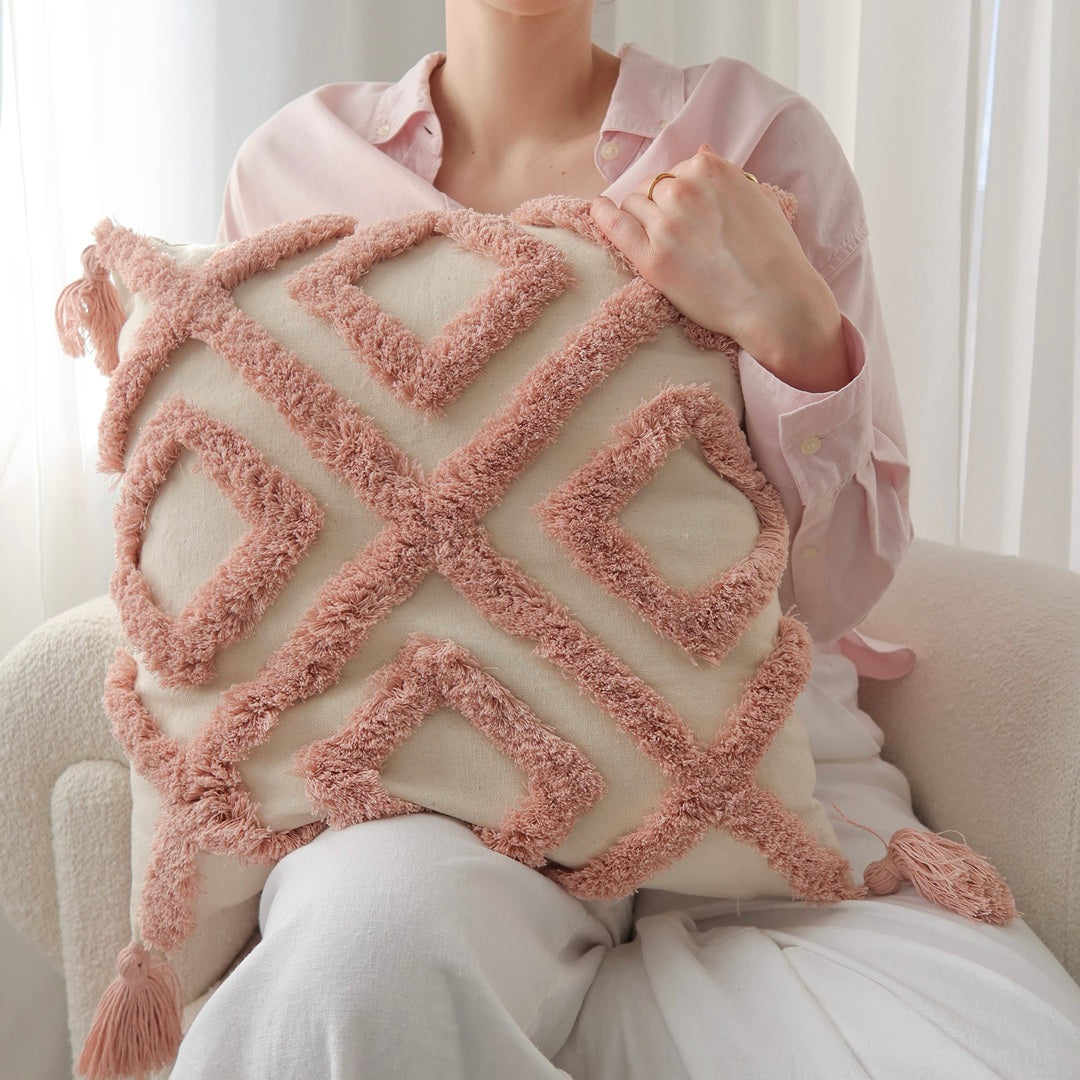 Decorative throw pillows with raised tufted patterns
