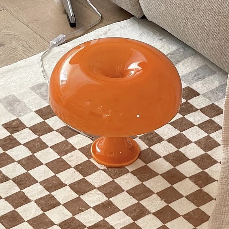 Orange mushroom table lamp on checkered rug