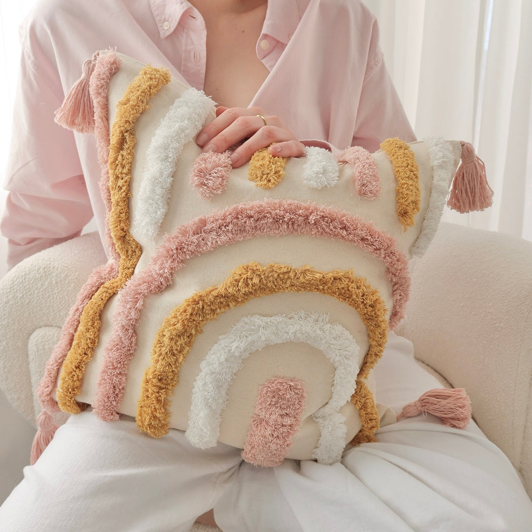 Set of boho-style tufted cushion covers in warm pastel tones