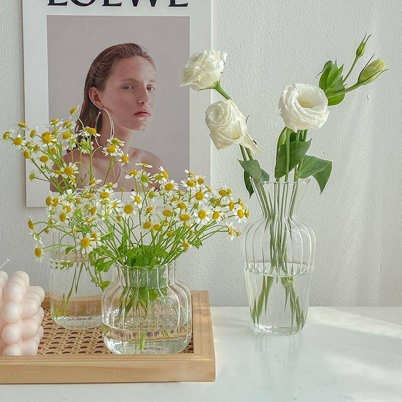 Glass vase with white flowers and chamomile bouquet