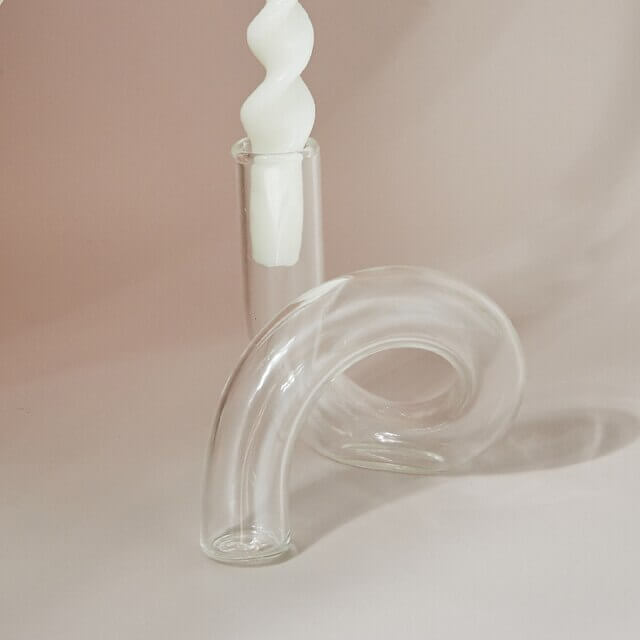 Unique glass vase with spiral design and candle
