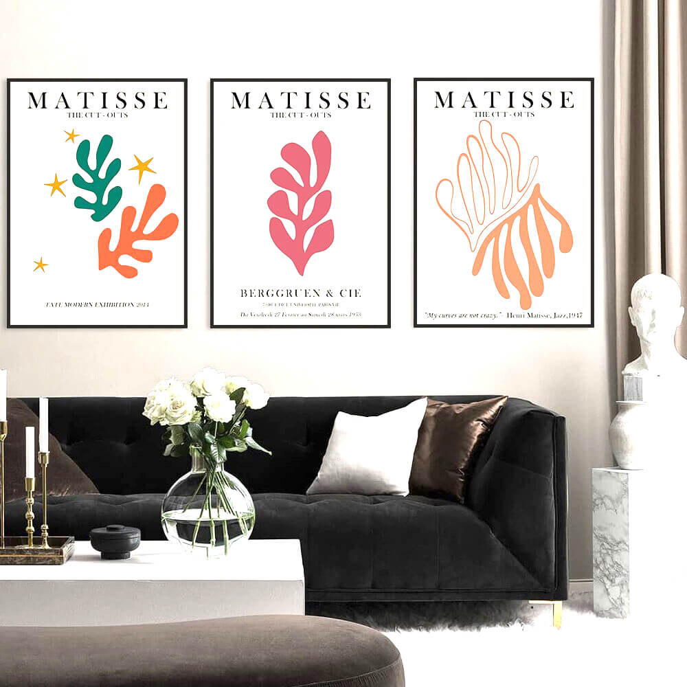 Matisse art prints above black couch in modern living room