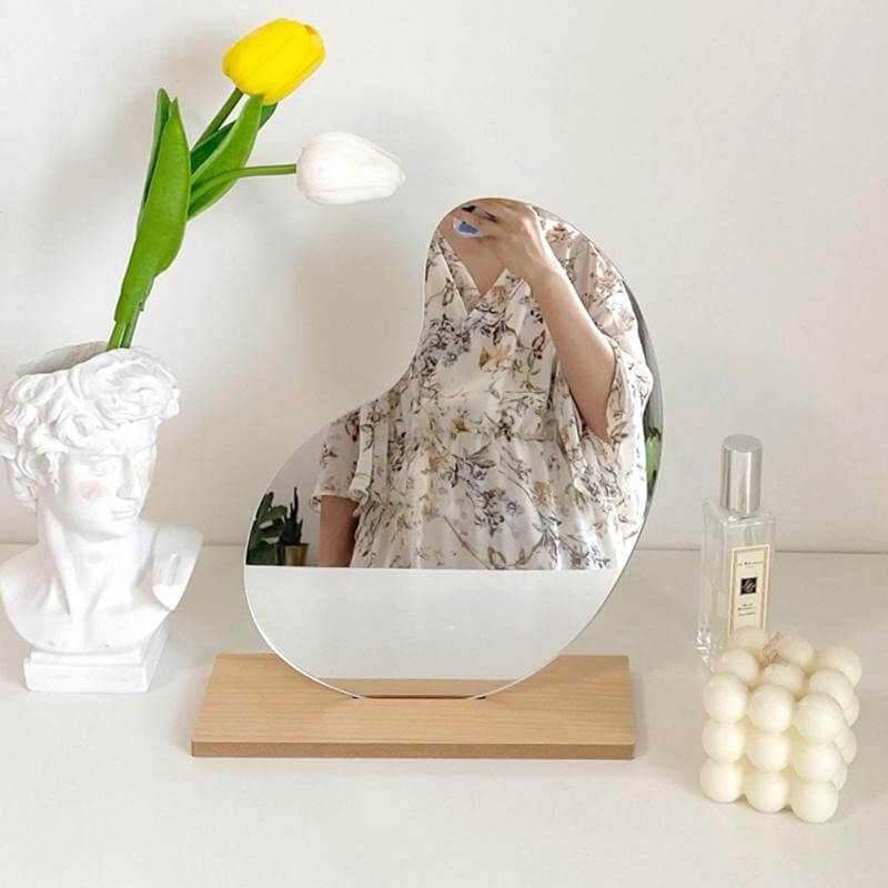 Korean style makeup mirror with storage reflecting a person.